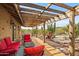 Covered patio with brick, desert landscaping, fire pit and furniture at 39606 N 3Rd Ave, Phoenix, AZ 85086
