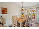 Charming dining room with rustic wood table and chairs, leading to an outdoor space with a fireplace at 39606 N 3Rd Ave, Phoenix, AZ 85086