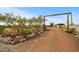 Expansive circular gravel driveway leading to the home with desert landscaping and wood beam entry at 39606 N 3Rd Ave, Phoenix, AZ 85086