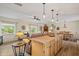 Warm and inviting living space with a central kitchen island, comfortable seating, and backyard views at 39606 N 3Rd Ave, Phoenix, AZ 85086