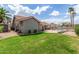 Large backyard featuring a spacious lawn, a pool area with fencing, and desert landscaping at 412 W Curry St, Chandler, AZ 85225