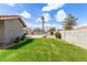 Well-maintained backyard with green grass, a pool area enclosed by fencing, and mature trees at 412 W Curry St, Chandler, AZ 85225