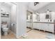 Bright bathroom with double sinks, tiled flooring, and a large sliding-door closet at 412 W Curry St, Chandler, AZ 85225