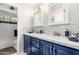 Well-lit bathroom featuring double sinks, and a tub with white subway tile and black accent trim at 412 W Curry St, Chandler, AZ 85225