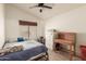 Bedroom featuring a dark ceiling fan and an exposed twin bed frame at 412 W Curry St, Chandler, AZ 85225