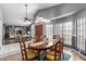 Bright dining room with a table for six, a ceiling fan, and an open view to the living room at 412 W Curry St, Chandler, AZ 85225