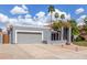 Lovely single-story home featuring mature palms, a two-car garage, and low-water landscaping at 412 W Curry St, Chandler, AZ 85225