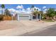 Attractive single-story home with mature palms, a two-car garage, and xeriscaping at 412 W Curry St, Chandler, AZ 85225