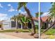Wonderful single-story home featuring a tile roof, palms, and an attractive desert front yard at 412 W Curry St, Chandler, AZ 85225