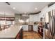 Modern kitchen features white cabinets, stainless steel appliances, and an island with a wine fridge at 412 W Curry St, Chandler, AZ 85225