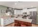 Modern kitchen features white cabinets, stainless steel appliances, and an island with bar stools at 412 W Curry St, Chandler, AZ 85225