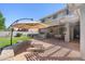 Expansive backyard featuring an outdoor kitchen, covered patio, fire pit, and seating area, perfect for entertaining guests at 4340 S Marble St, Gilbert, AZ 85297