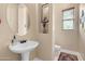 Charming powder room with pedestal sink, stylish mirror, and elegant decor at 4340 S Marble St, Gilbert, AZ 85297