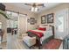 Well-lit bedroom featuring wood floors, a comfortable bed, and charming decor at 4340 S Marble St, Gilbert, AZ 85297