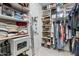 Spacious walk-in closet with organized shelves and hanging rods for optimal storage at 4340 S Marble St, Gilbert, AZ 85297