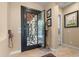 Inviting entryway with a decorative iron door, tiled flooring, and stylish accents, creating a warm and welcoming first impression at 4340 S Marble St, Gilbert, AZ 85297