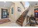 Elegant entryway features decorative iron door, tile flooring, staircase with iron railings, and art adornments at 4340 S Marble St, Gilbert, AZ 85297