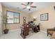 An organized home office space with a dark wood desk, comfortable chair, and natural lighting at 4340 S Marble St, Gilbert, AZ 85297