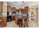 Spacious kitchen boasts an island, stainless appliances, dark wood cabinets, and elegant backsplash at 4340 S Marble St, Gilbert, AZ 85297