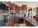 Well-equipped kitchen features stainless steel appliances, granite countertops, wood cabinets, and modern backsplash at 4340 S Marble St, Gilbert, AZ 85297
