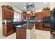 This spacious kitchen features wooden cabinets, granite counters, and stainless steel appliances at 4340 S Marble St, Gilbert, AZ 85297