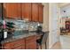 Kitchen desk area features wooden cabinets, granite counters and is situated near pantry at 4340 S Marble St, Gilbert, AZ 85297