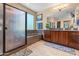 Main bathroom features a glass-enclosed shower, soaking tub, and double vanity with attractive countertops at 4340 S Marble St, Gilbert, AZ 85297