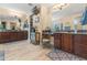 Main bathroom with double vanity, vanity seating, walk-in closet and custom decor throughout at 4340 S Marble St, Gilbert, AZ 85297