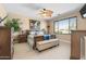 Bright main bedroom features a ceiling fan, plush carpet, large window, and stylish furnishings at 4340 S Marble St, Gilbert, AZ 85297