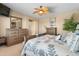 Spacious main bedroom features neutral tones, a ceiling fan, and natural light from the large window at 4340 S Marble St, Gilbert, AZ 85297