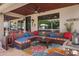 Cozy covered patio with comfortable seating, ceiling fan, and decorative accents, creating an inviting outdoor living space at 4340 S Marble St, Gilbert, AZ 85297
