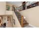 Grand staircase features iron railings, stone accents, wood stairs, and bright natural light from high windows at 4340 S Marble St, Gilbert, AZ 85297