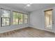 Bedroom featuring natural light from three windows, complemented by stylish wood-look flooring at 4777 S Fulton Ranch Blvd # 1029, Chandler, AZ 85248