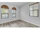 Bright bedroom featuring wood-look floors and modern windows with wooden-slatted blinds at 4777 S Fulton Ranch Blvd # 1029, Chandler, AZ 85248