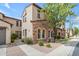 A charming home exterior featuring stone accents, arched windows, and a neatly landscaped front yard with walkway at 4777 S Fulton Ranch Blvd # 1029, Chandler, AZ 85248