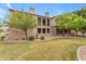 Elegant home with a manicured lawn, stone accents, balcony, and mature trees at 4777 S Fulton Ranch Blvd # 1029, Chandler, AZ 85248