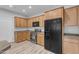 Kitchen featuring wood cabinets, black appliances and countertops at 4777 S Fulton Ranch Blvd # 1029, Chandler, AZ 85248
