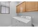 Laundry room with wood cabinets and a Maytag washer and dryer at 4777 S Fulton Ranch Blvd # 1029, Chandler, AZ 85248