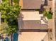 Bird's eye view of a house with a pool, adjacent to lush trees and well-maintained rooftops at 4809 W Erie St, Chandler, AZ 85226