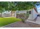 Charming backyard with lush artificial grass and mature trees for added privacy and shade at 4809 W Erie St, Chandler, AZ 85226