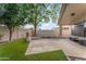 Beautiful backyard with artificial grass, a covered patio, and mature trees for a relaxing outdoor space at 4809 W Erie St, Chandler, AZ 85226