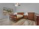 The main bedroom features wooden floors, matching furniture, a ceiling fan, and a large window at 4809 W Erie St, Chandler, AZ 85226