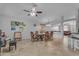Bright dining area featuring a table with chairs, ceiling fan, and connecting kitchen, ideal for Gathering dining at 4809 W Erie St, Chandler, AZ 85226