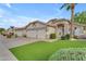 Inviting home featuring a wide driveway, spacious two-car garage, and lush landscaping at 4809 W Erie St, Chandler, AZ 85226