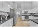 Bright kitchen featuring white cabinetry, stainless steel appliances, and an opening view to the hallway at 4809 W Erie St, Chandler, AZ 85226