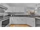 Bright kitchen featuring white cabinetry, stainless steel appliances, and granite countertops at 4809 W Erie St, Chandler, AZ 85226