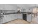 Open kitchen featuring white cabinetry, stainless steel appliances, a view to the backyard, and an eating area at 4809 W Erie St, Chandler, AZ 85226