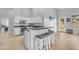 Eat-in kitchen featuring white cabinetry, a black countertop, and barstool seating near an exit to the backyard at 4809 W Erie St, Chandler, AZ 85226