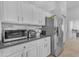 Bright kitchen featuring white cabinetry, stainless steel appliances, and ample countertop space for cooking at 4809 W Erie St, Chandler, AZ 85226