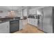 Bright kitchen featuring white cabinetry, stainless steel appliances, and a view of the hallway and living area at 4809 W Erie St, Chandler, AZ 85226